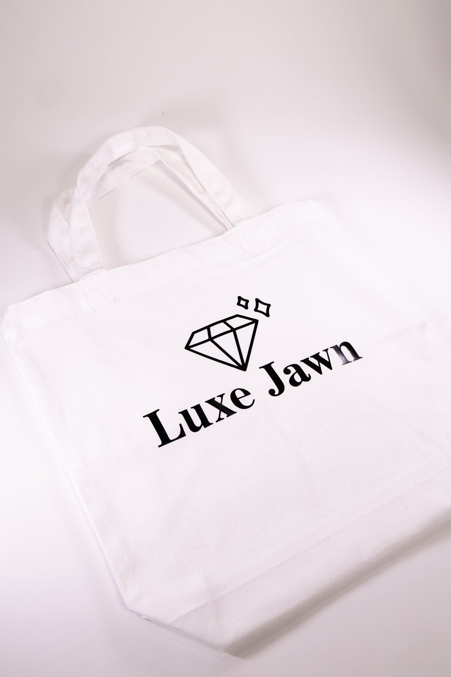 White Canvas Tote with words Luxe Jawn