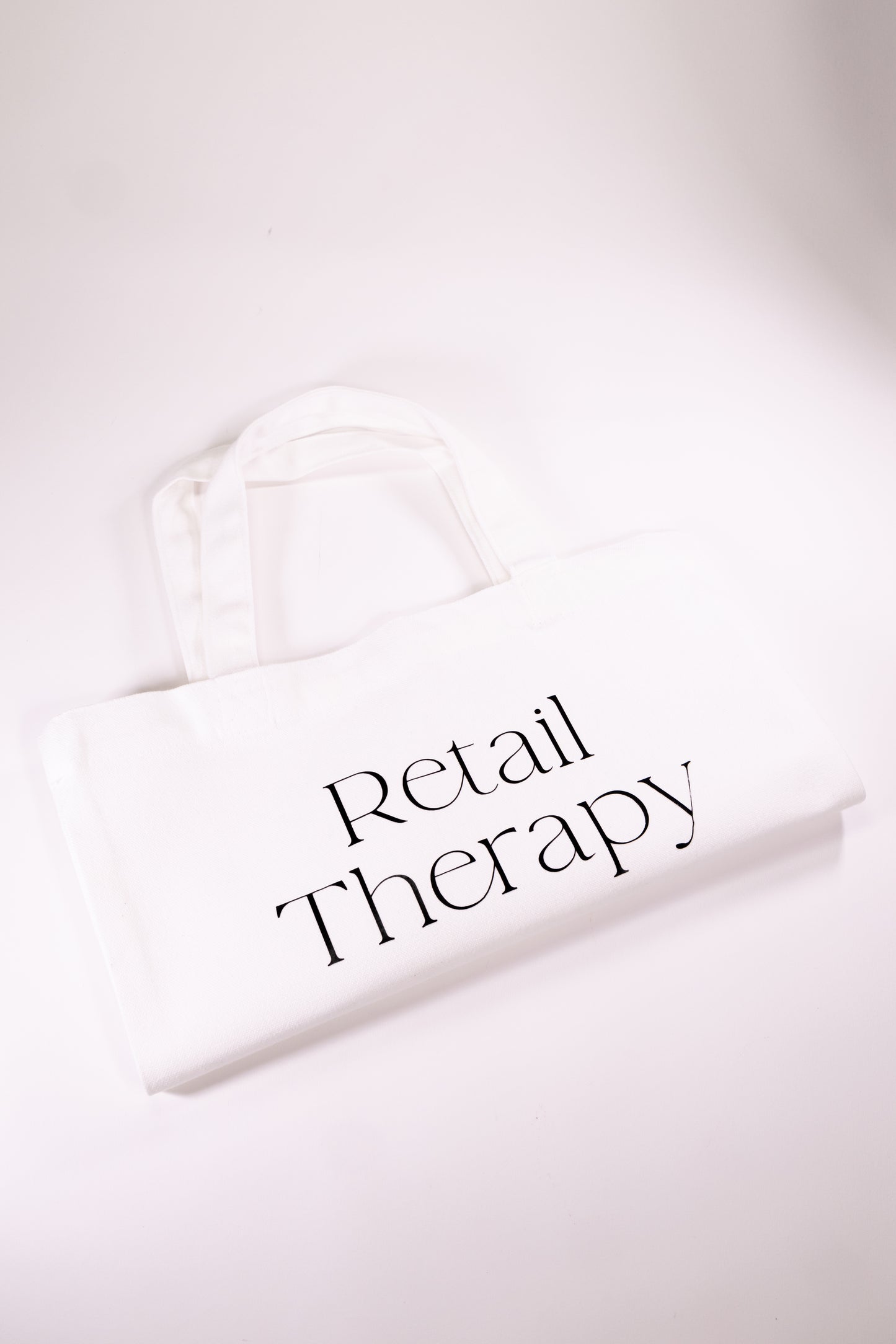 White canvas tote with words Retail Therapy