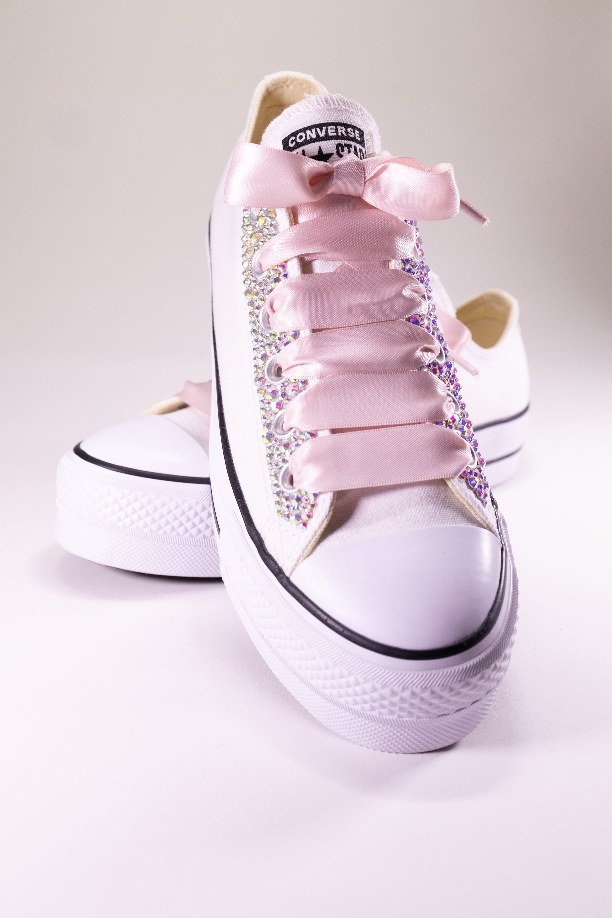 White Converse sneakers with pink laces and beautiful rhinestone embellishments
