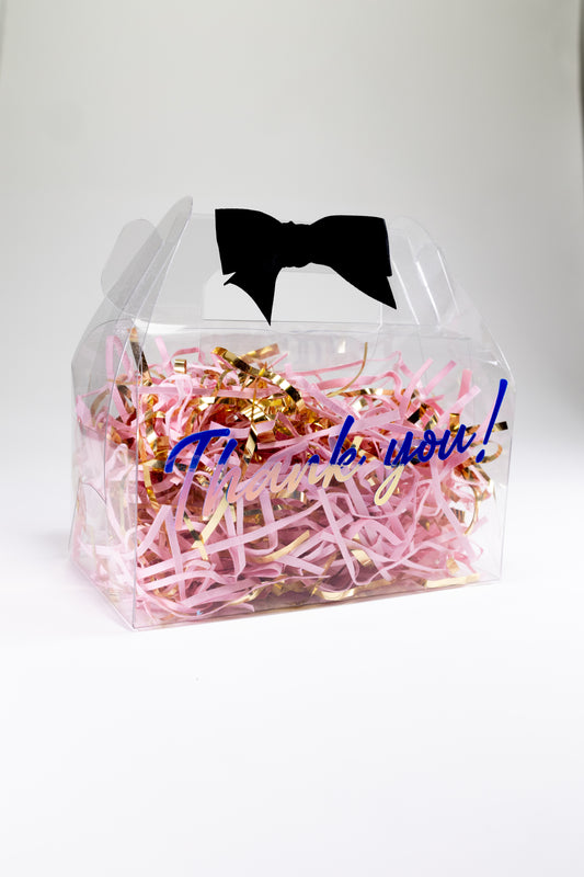 Clear gable box with pink and gold confetti and a black bow 