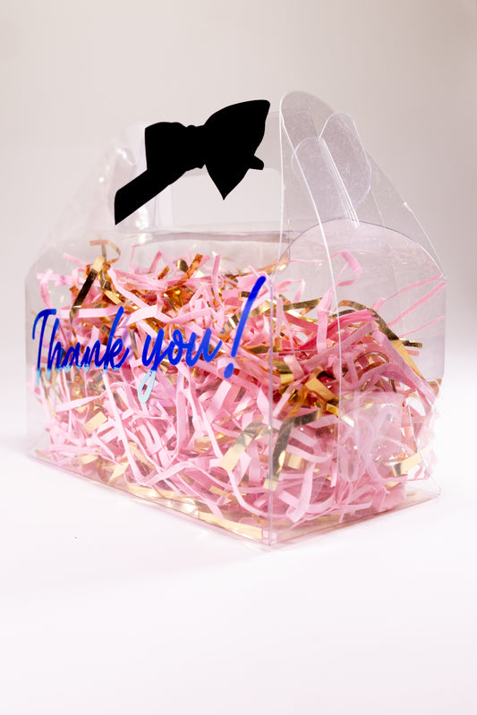 Clear gable box with pink and gold confetti and a black bow 
