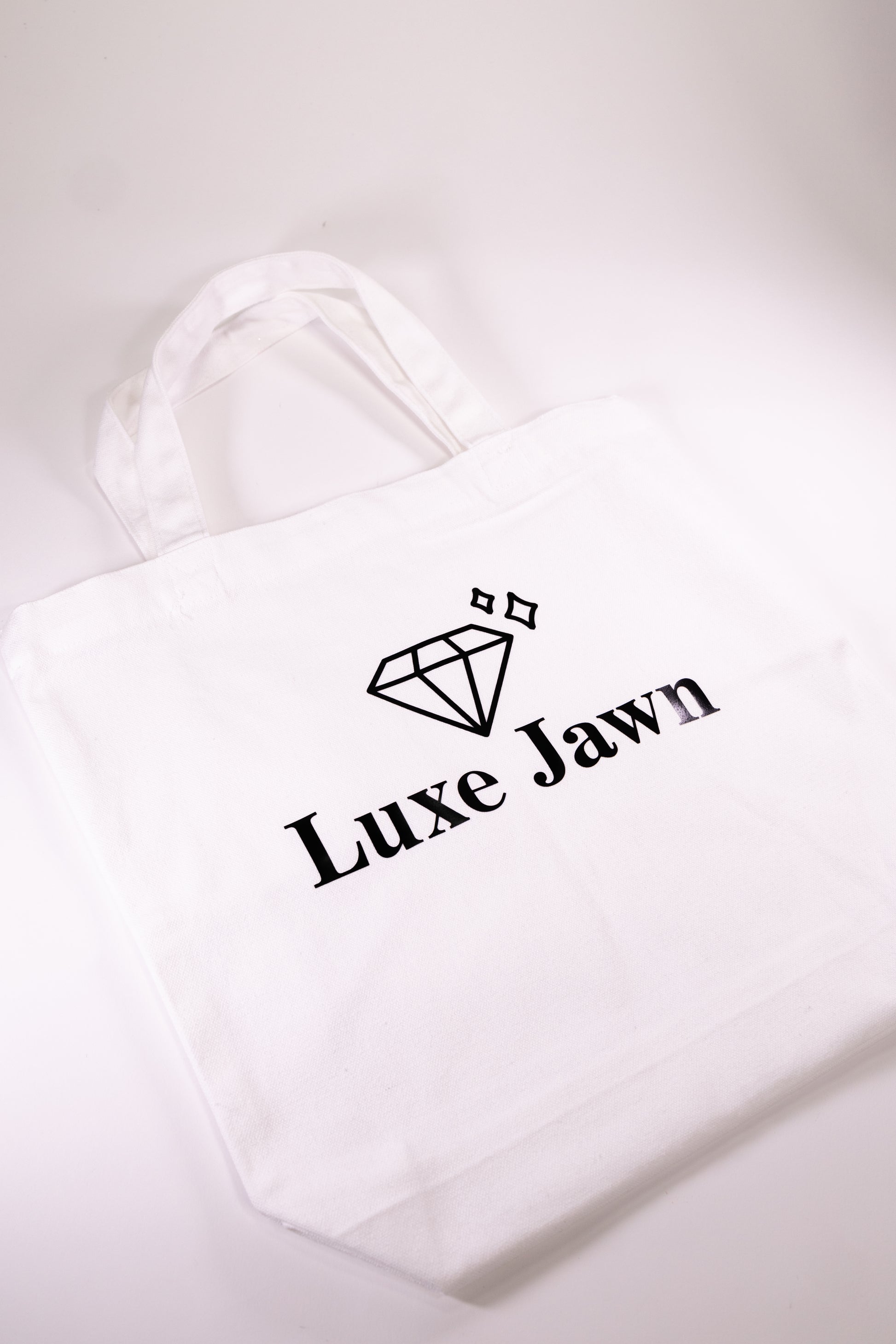 White Canvas Tote with words Luxe Jawn